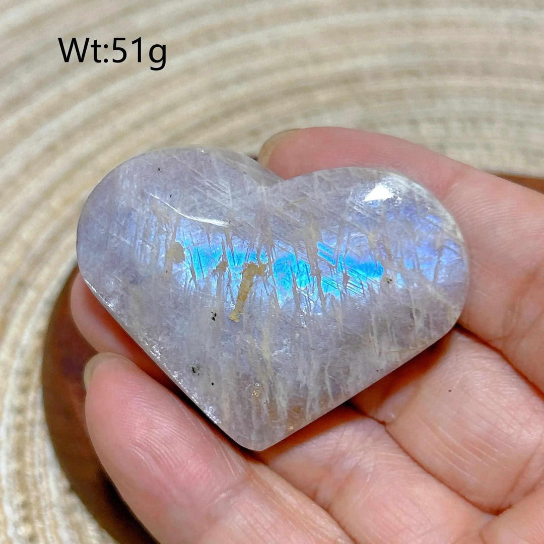 Polished 51g Rainbow Moonstone and Sunstone heart featuring a milky white surface with vibrant blue flashes and sparkle.