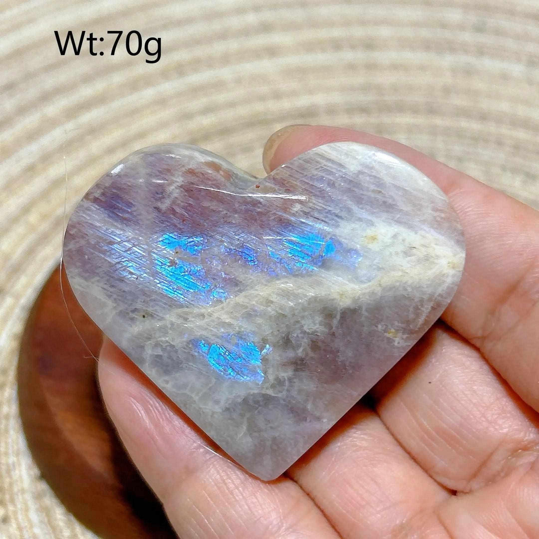 Polished Rainbow Moonstone and Sunstone heart with milky white tones, warm orange hues, and vibrant blue flashes.