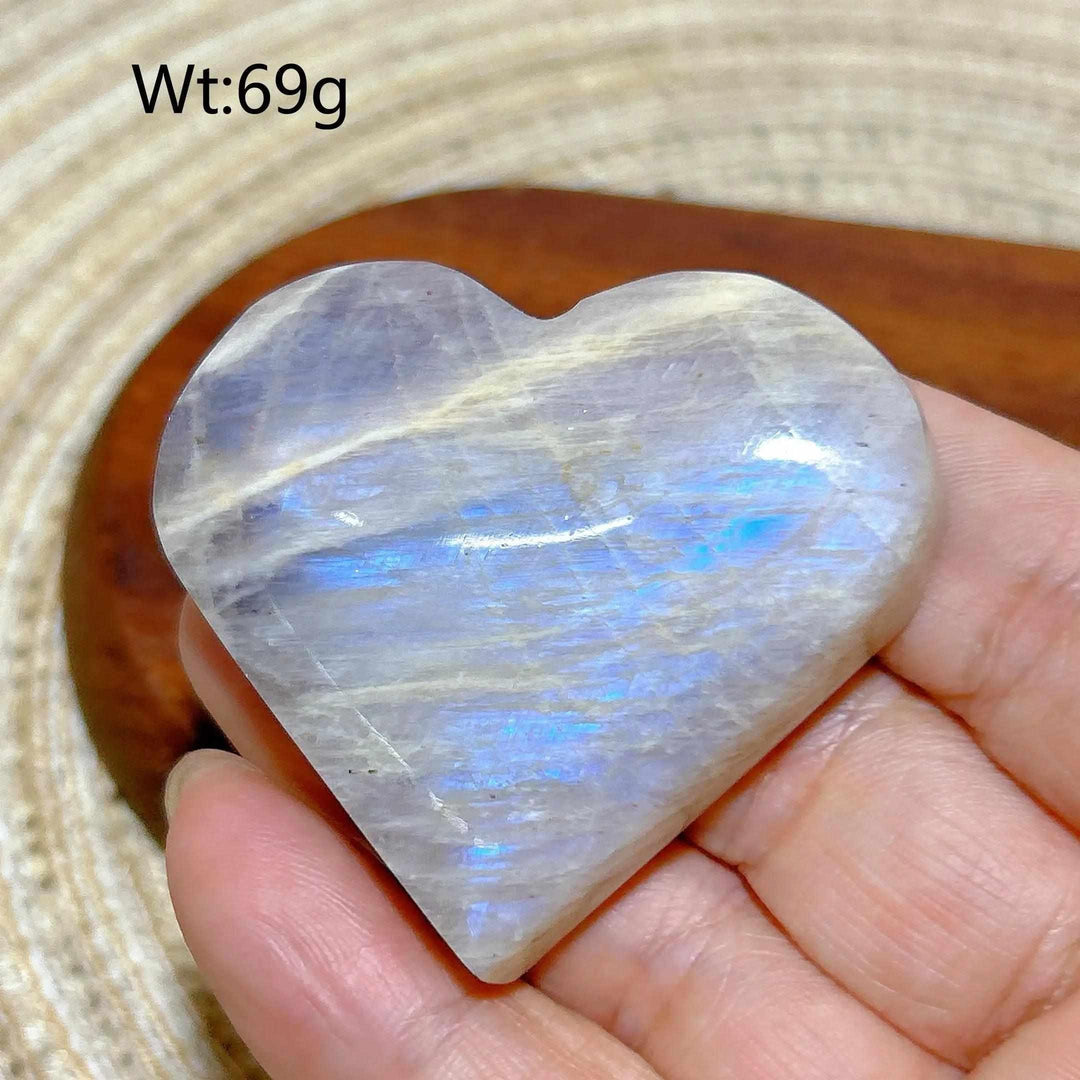 Polished 69g Rainbow Moonstone and Sunstone heart featuring milky white tones and vibrant blue flashes for chakra balance.
