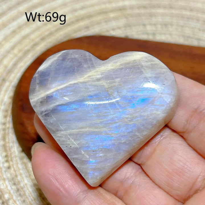 Polished 69g Rainbow Moonstone and Sunstone heart featuring milky white tones and vibrant blue flashes for chakra balance.