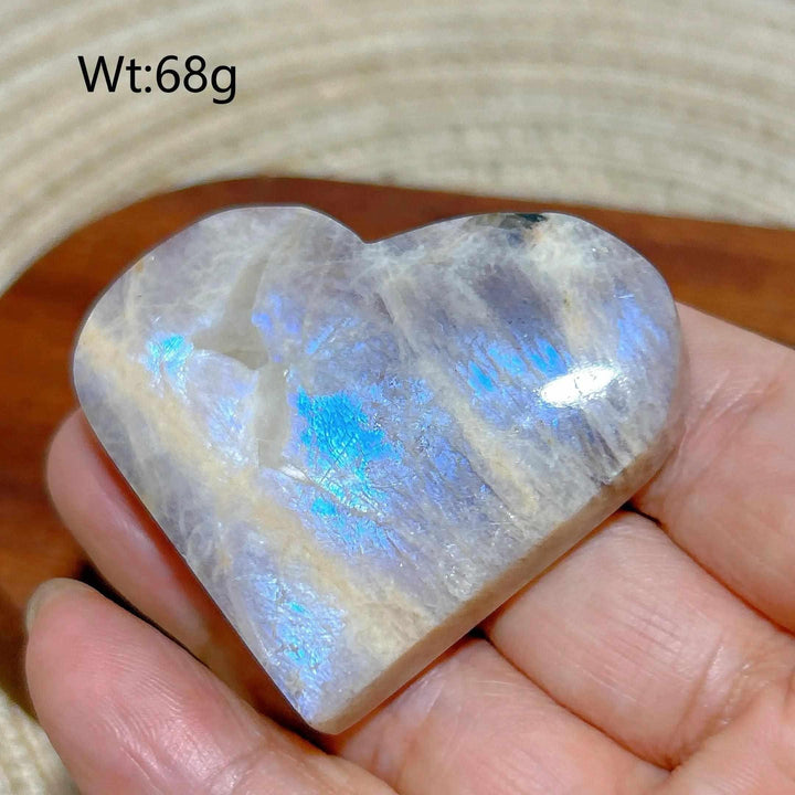 Polished 68g Rainbow Moonstone and Sunstone heart featuring milky white tones and vibrant blue flashes of light.
