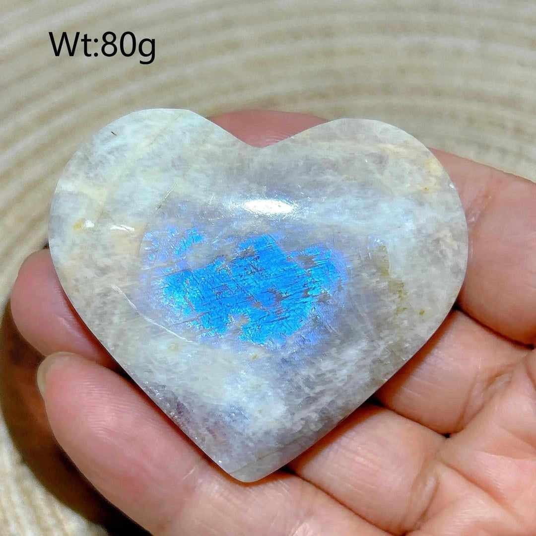 Polished 80g Rainbow Moonstone and Sunstone heart featuring a vibrant blue flash and warm, glittering energy.