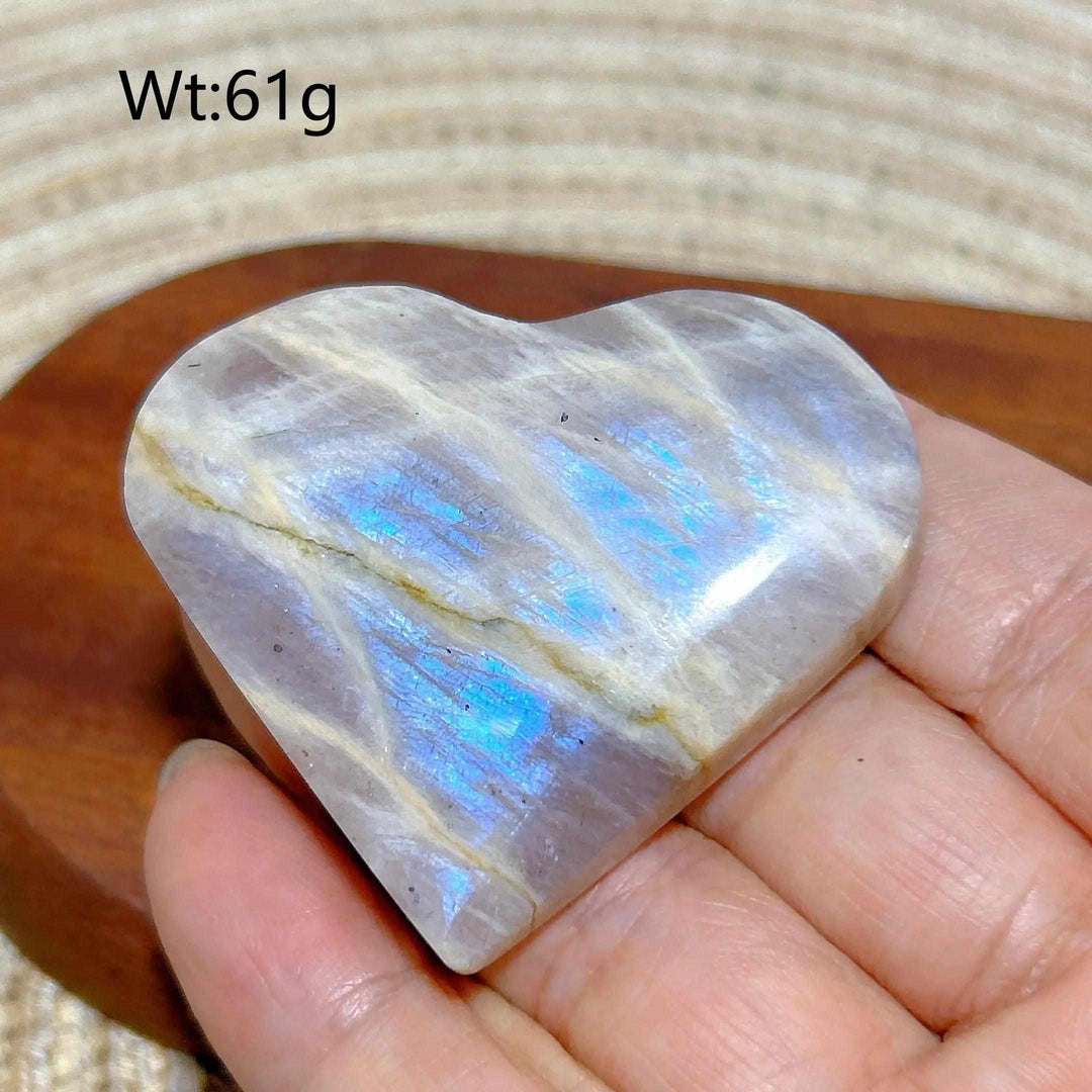 Polished Rainbow Moonstone and Sunstone heart featuring milky white tones, warm orange hues, and a vibrant blue flash.