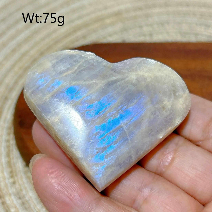Polished 75g Rainbow Moonstone and Sunstone heart featuring milky white tones and vibrant blue flashes for chakra balance.