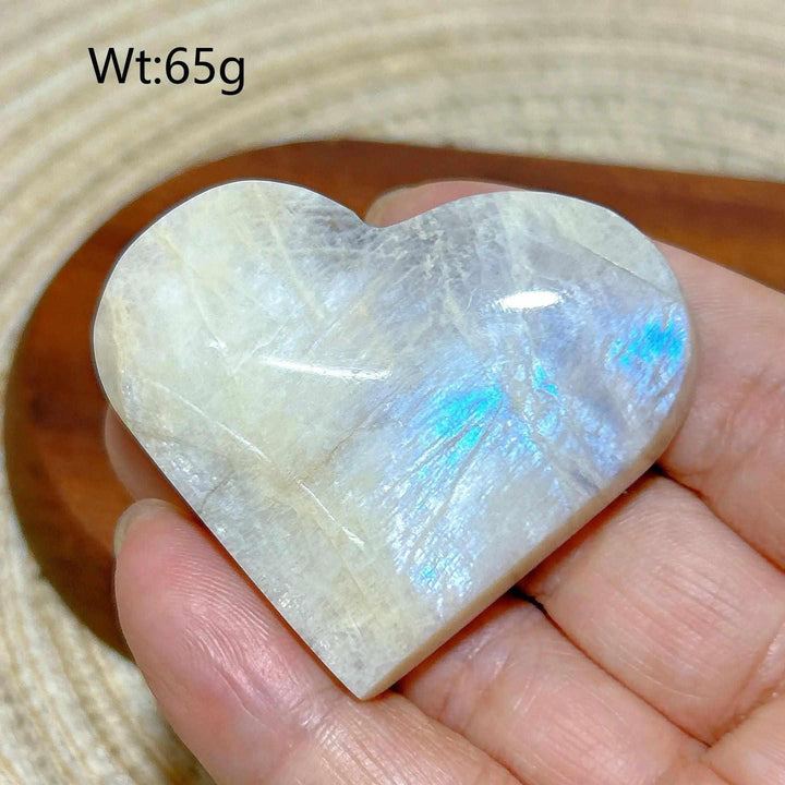 Polished 65g Rainbow Moonstone and Sunstone heart featuring milky white tones, warm orange hues, and a soft blue flash.