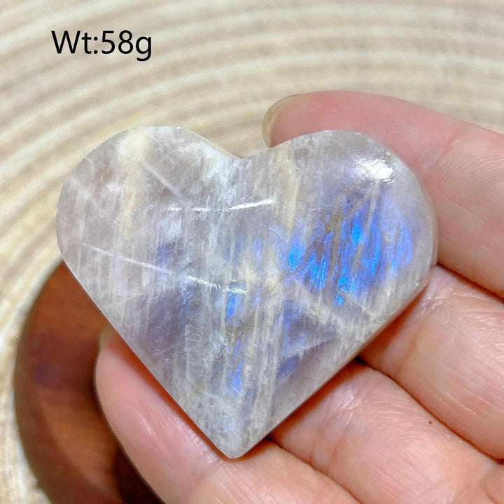 Polished 58g Rainbow Moonstone and Sunstone heart featuring milky white tones and vibrant blue flashes for chakra balance.