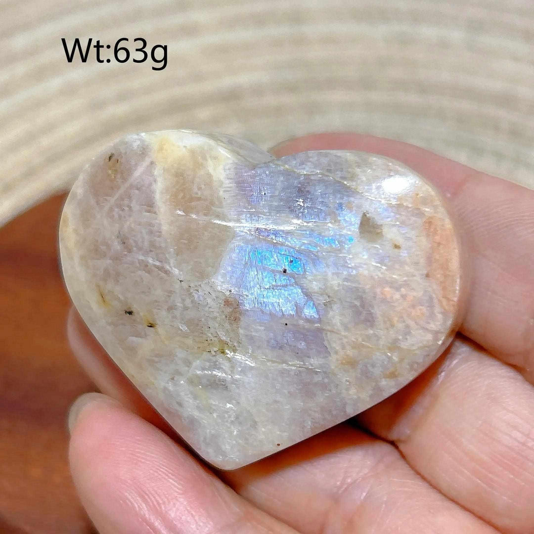 Polished Rainbow Moonstone and Sunstone heart with soft white and orange flashes, balancing intuition and warmth.