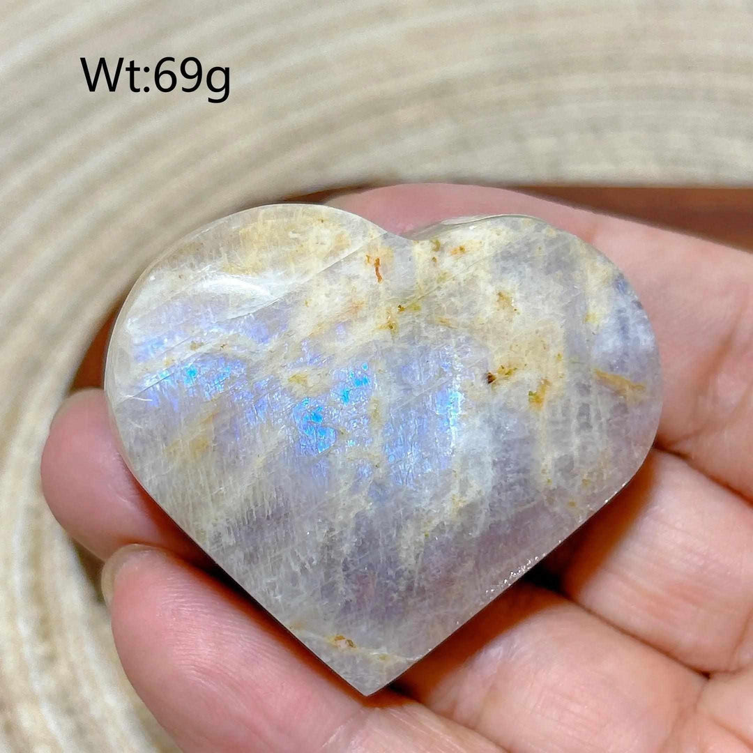 Polished Rainbow Moonstone and Sunstone heart featuring milky white tones, warm orange flashes, and 69g weight.