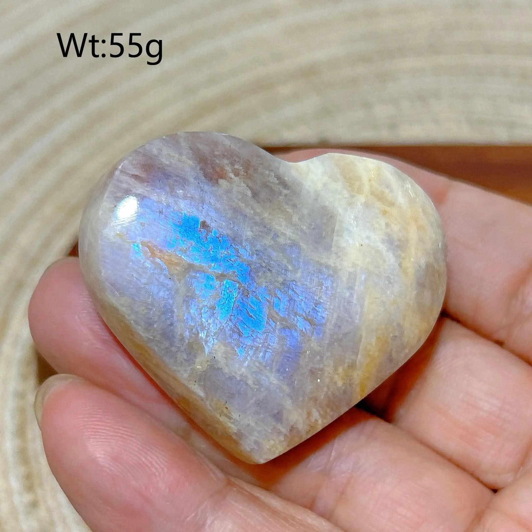 Polished Rainbow Moonstone and Sunstone heart featuring milky white and orange tones with a vibrant blue flash.