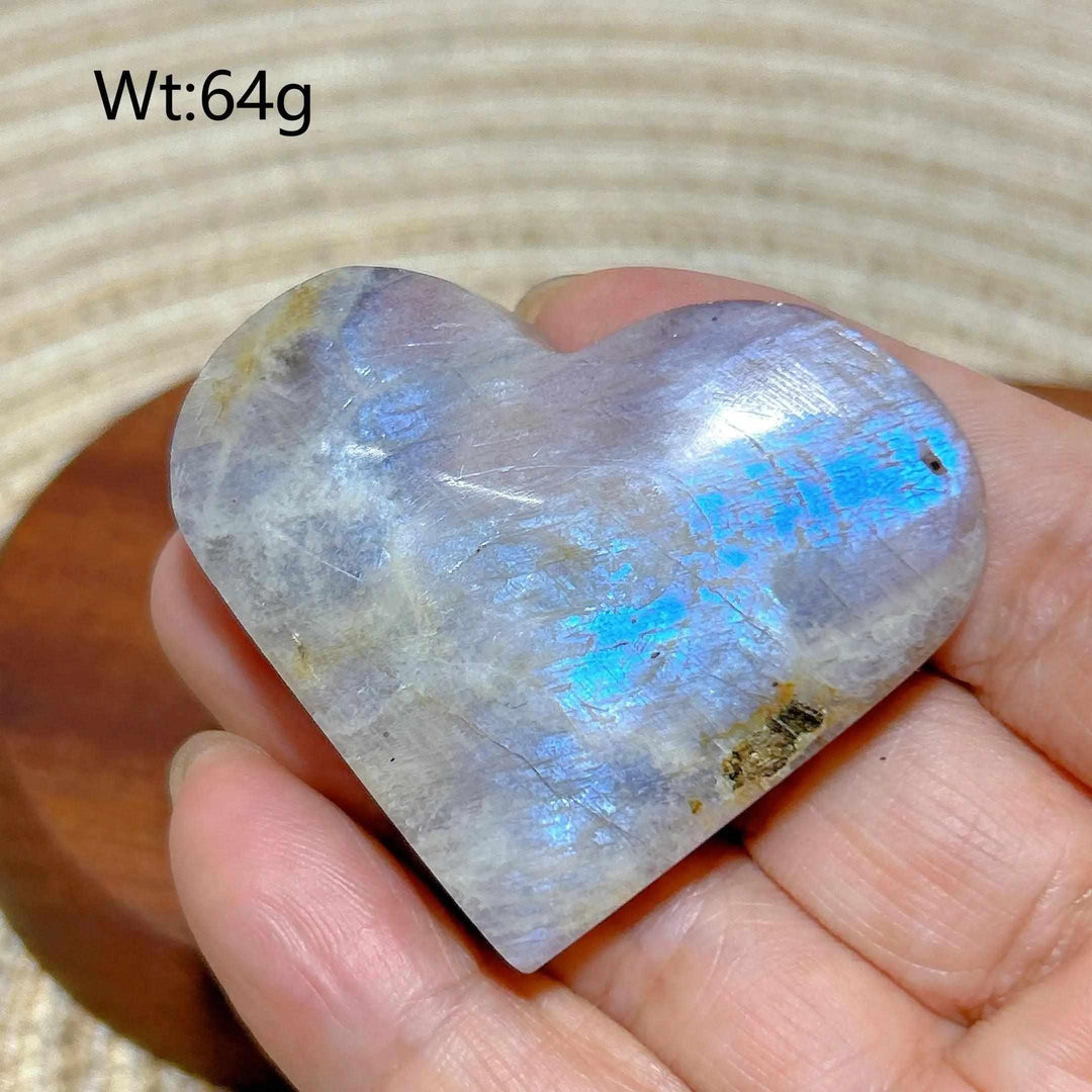 Polished 64g Rainbow Moonstone and Sunstone heart featuring milky white tones and vibrant blue flashes for chakra balance.