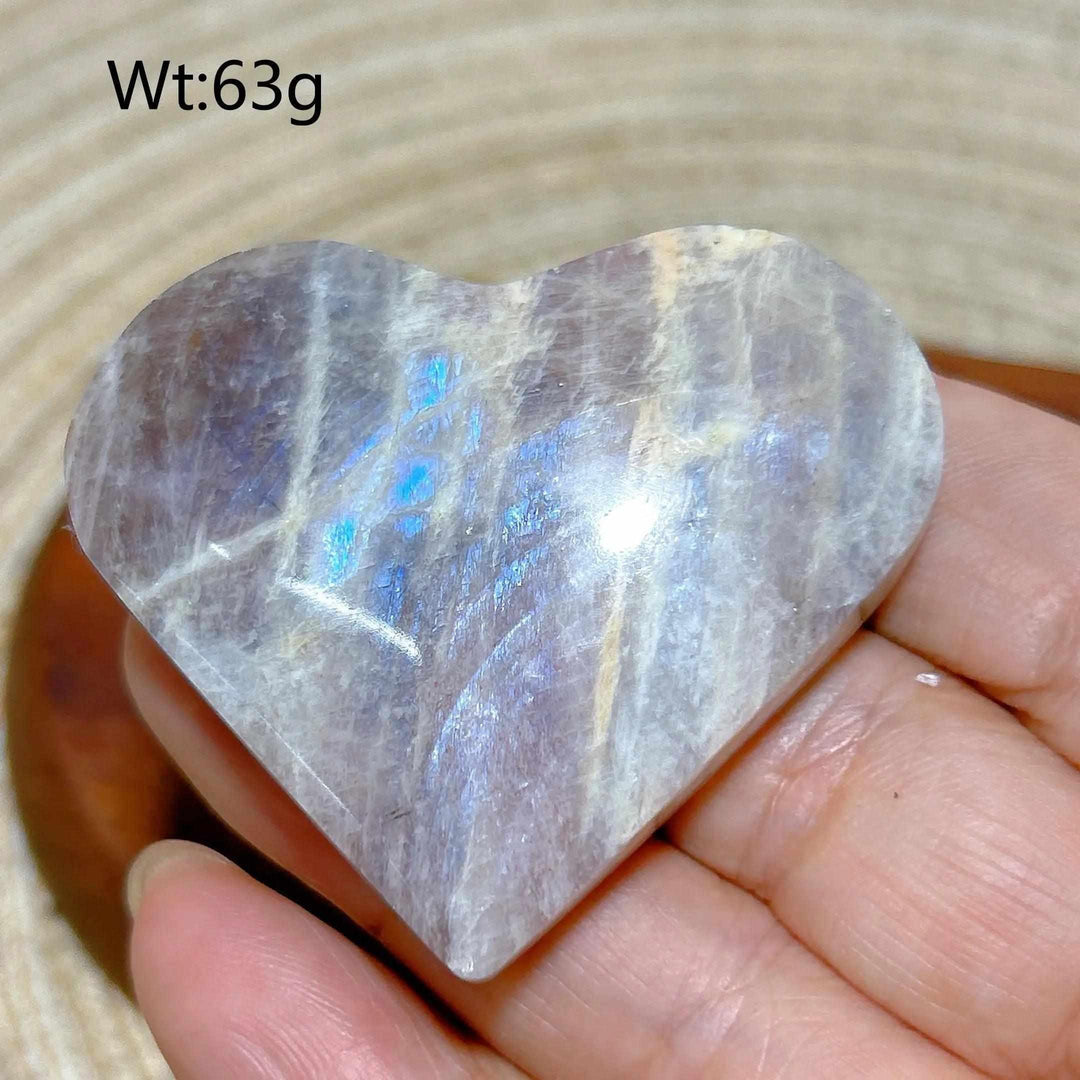 Polished 63g Rainbow Moonstone and Sunstone heart featuring milky white tones, warm orange hues, and soft blue flashes.