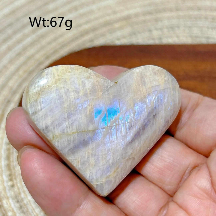 Polished 67g Rainbow Moonstone and Sunstone heart featuring milky white tones, warm orange hues, and a soft blue flash.