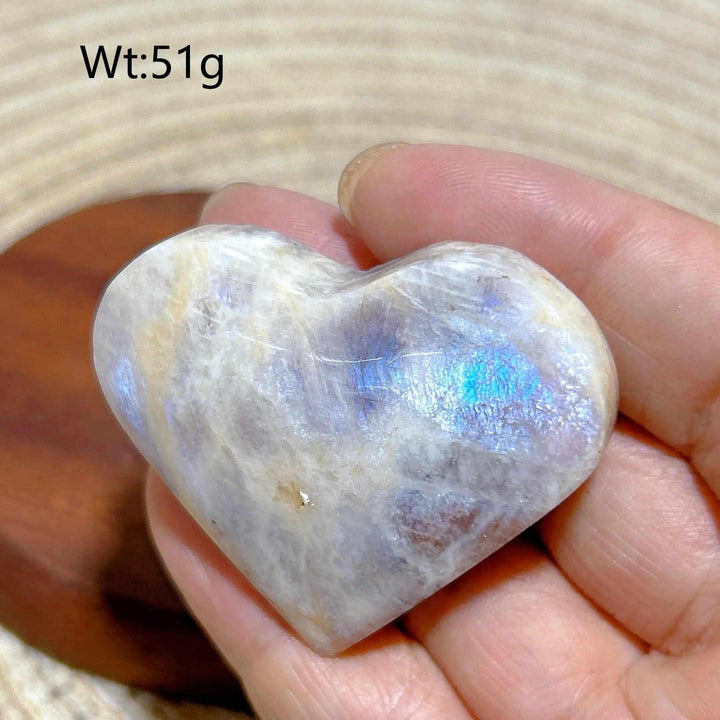 Polished 51g Rainbow Moonstone and Sunstone heart featuring milky white tones, warm orange hues, and a vibrant blue flash.