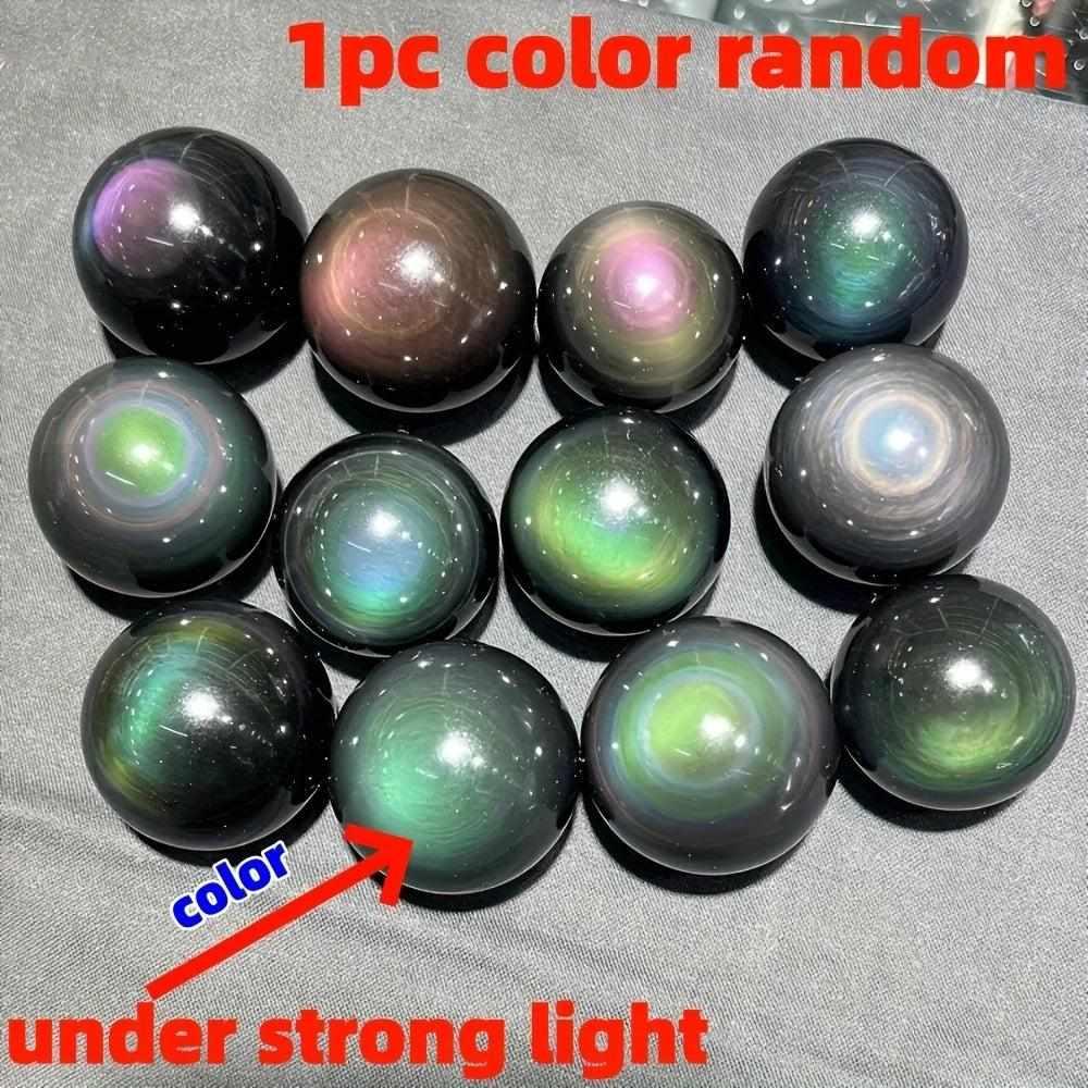 Polished Rainbow Obsidian spheres showing vibrant, iridescent color bands under light for root chakra protection.