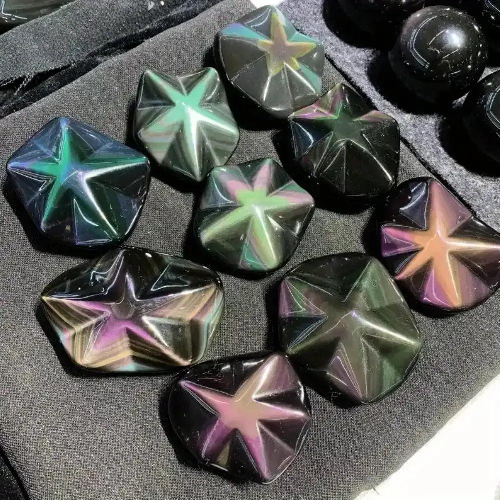 Hand-carved Rainbow Obsidian star crystals with shimmering purple, green, and gold flashes for grounding and protection.