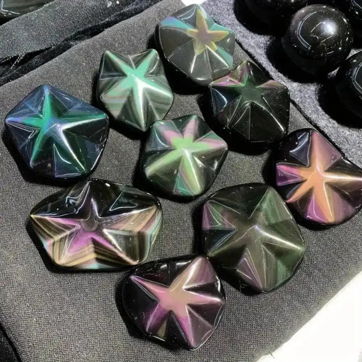 Hand-carved Rainbow Obsidian star crystals with shimmering purple, green, and gold flashes for grounding and protection.
