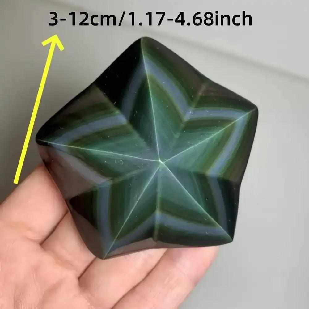 Hand-carved Rainbow Obsidian star with a polished black finish and vibrant green, purple, and gold light-reflecting bands.