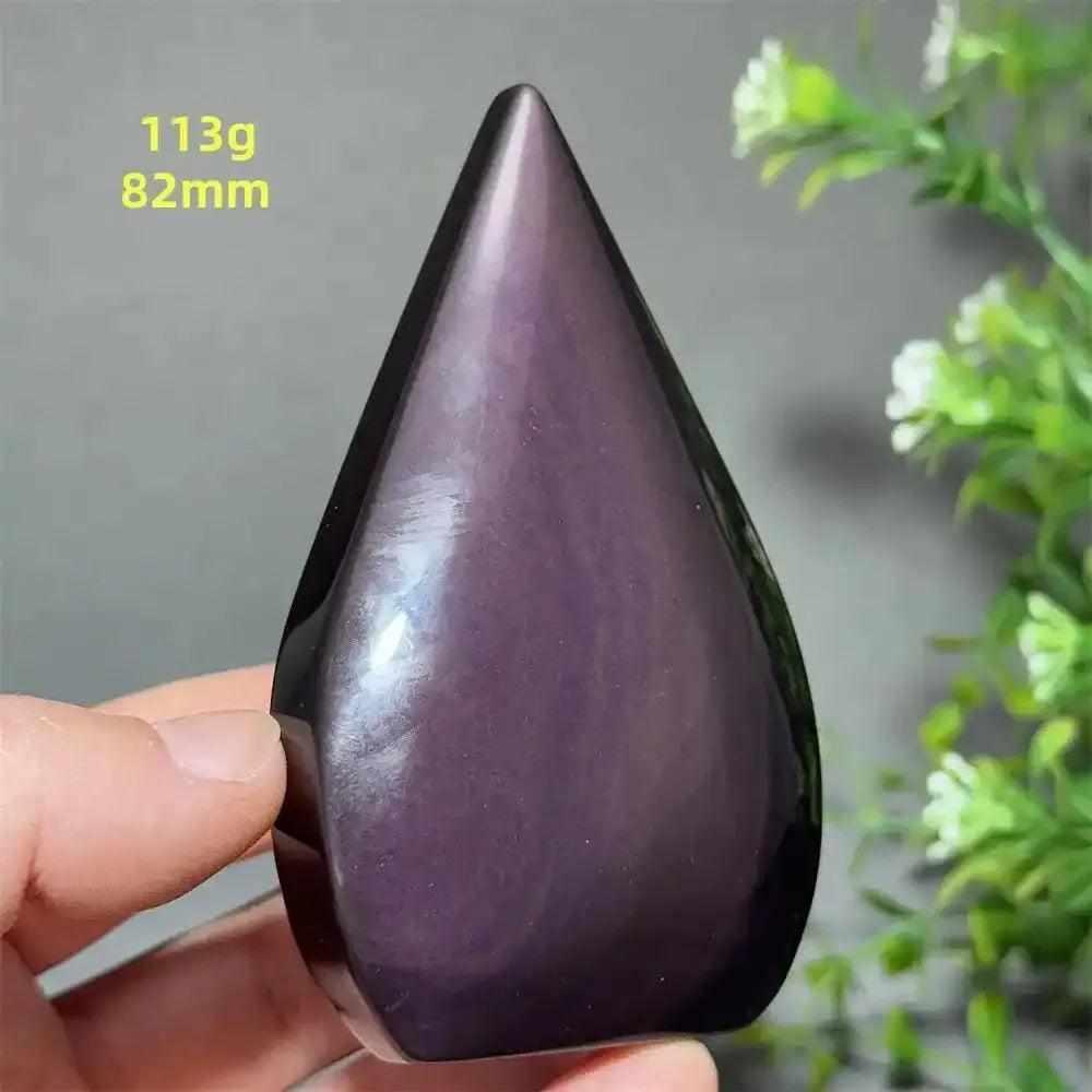 Polished Rainbow Obsidian torch freeform with a purple sheen, grounding volcanic glass in a flame shape for meditation.