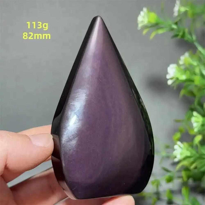 Polished Rainbow Obsidian torch freeform with a purple sheen, grounding volcanic glass in a flame shape for meditation.