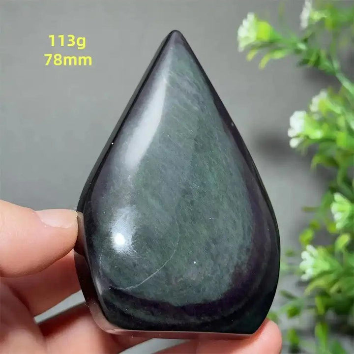 Polished Rainbow Obsidian torch freeform with a grounding black volcanic glass finish and shimmering purple and green sheen.