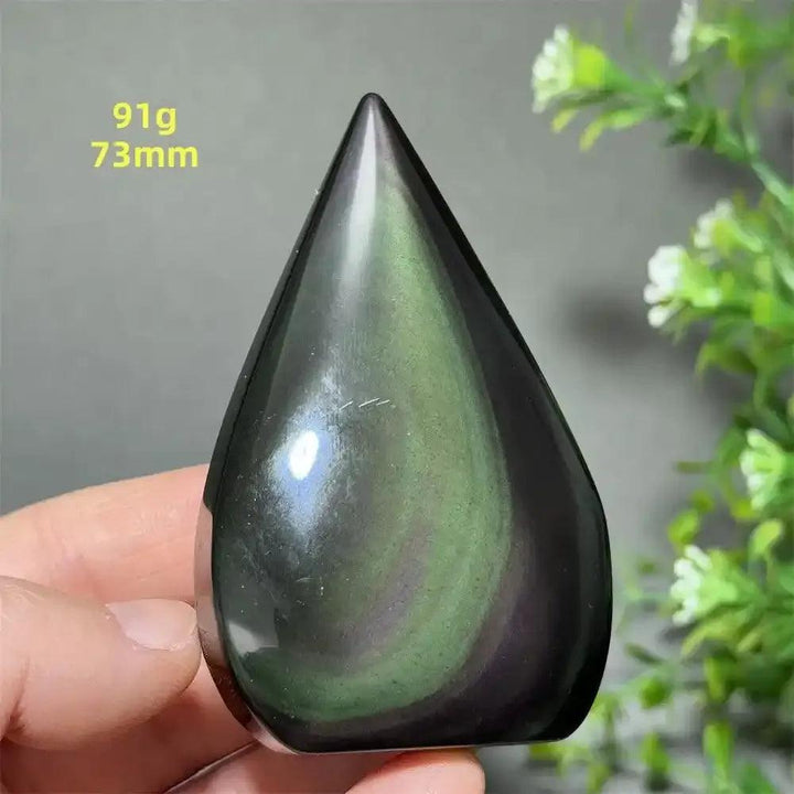 Polished Rainbow Obsidian torch freeform featuring a grounding black volcanic glass with vibrant green and purple sheen.