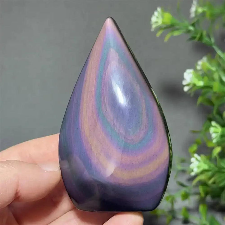 Polished Rainbow Obsidian torch freeform featuring vibrant purple, green, and gold flashes for grounding and protection.
