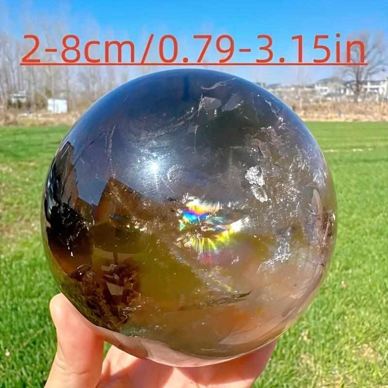 Polished Rainbow Smoky Quartz sphere in smoky gray with internal rainbow flashes for grounding and root chakra healing.