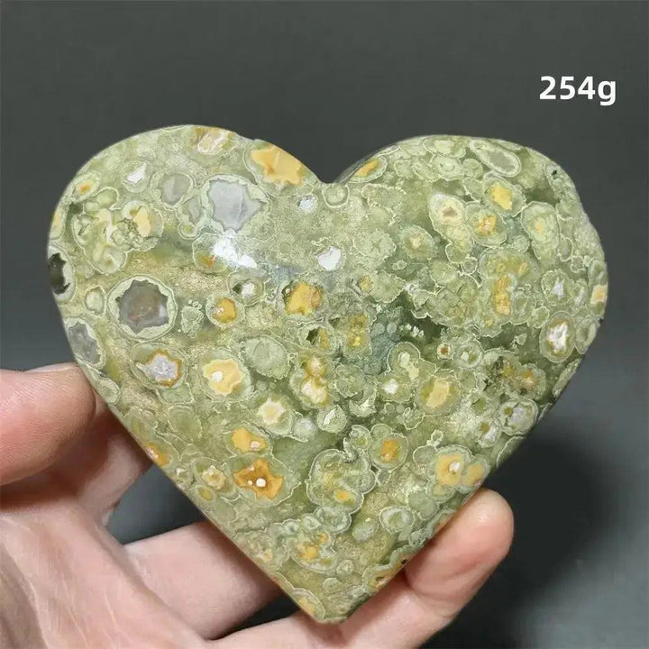 Rainforest Jasper Heart Healing Crystal: Green, yellow, and white patterned heart-shaped Rhyolite for emotional grounding.