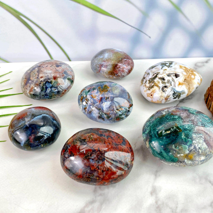 Polished Ocean Jasper palm stones featuring vibrant natural colors and unique patterns for healing and home decor.