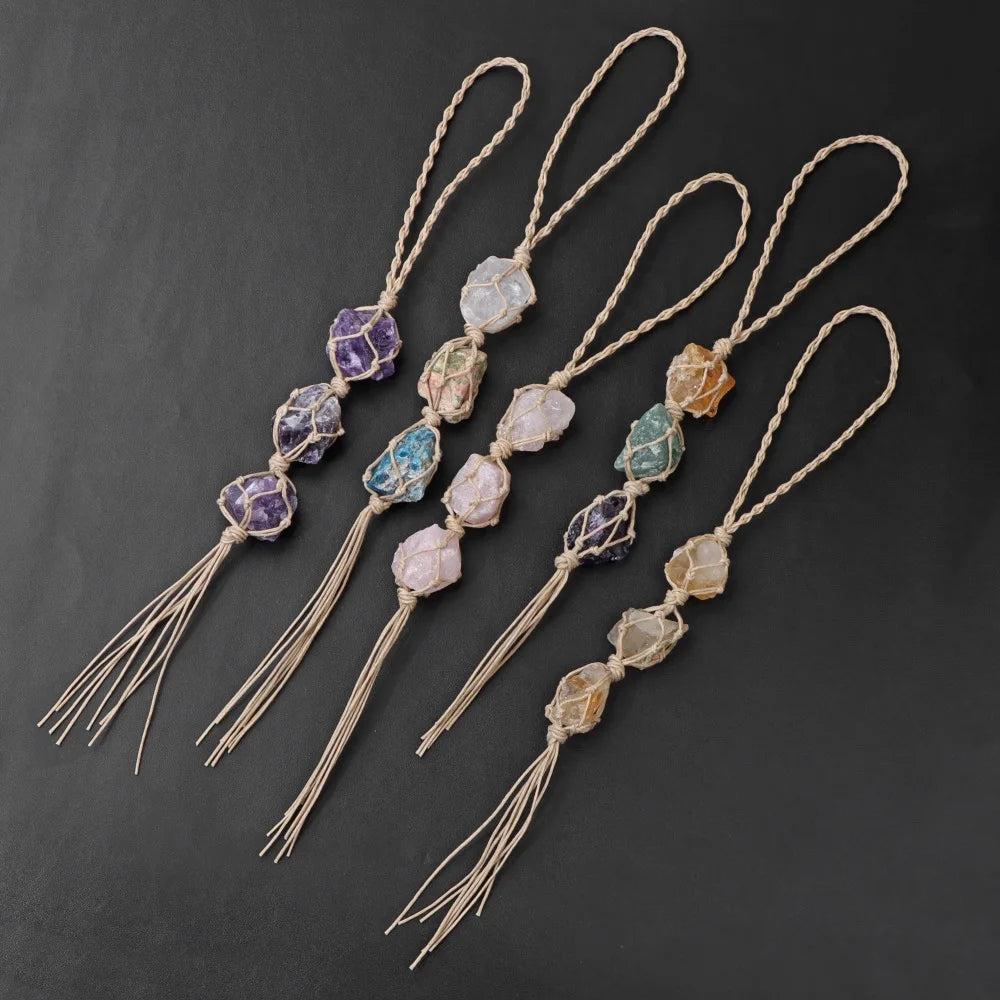 Assorted raw quartz crystal rearview mirror pendants with macrame cords and tassels, promoting positive energy.