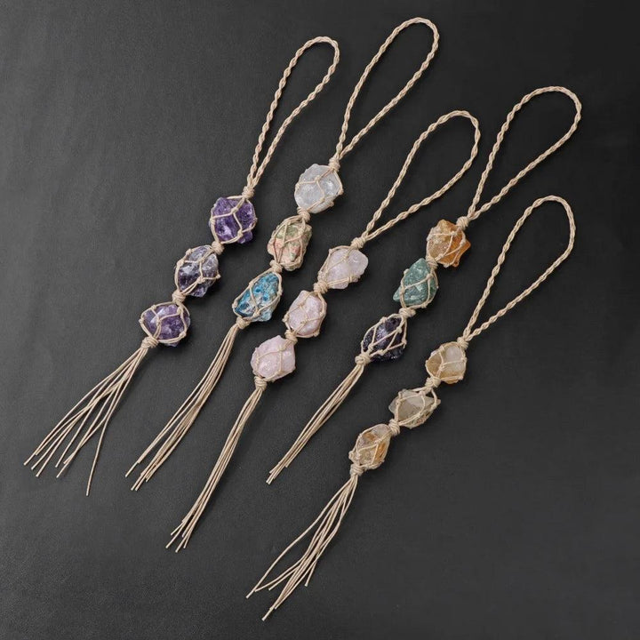 Assorted raw quartz crystal rearview mirror pendants with macrame cords and tassels, promoting positive energy.