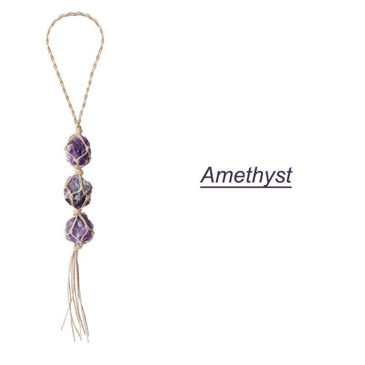 Three raw, irregular amethyst stones in macrame netting, forming a car rearview mirror pendant with a braided loop.