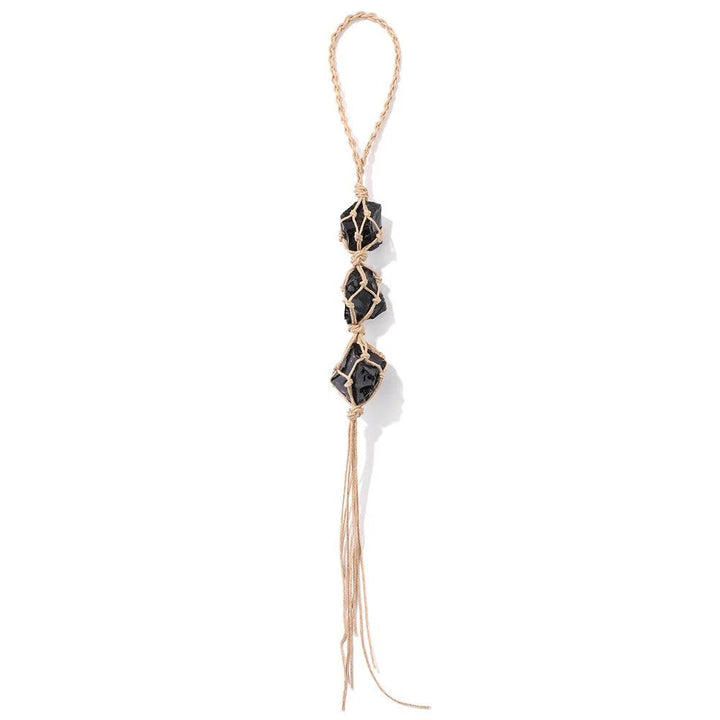 Three raw black tourmaline stones wrapped in natural twine, forming a car rearview mirror pendant.
