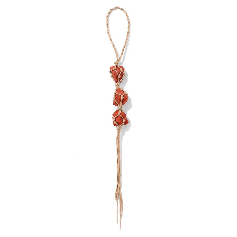 Red raw quartz stone car pendant with three irregular crystals in a macrame net, promoting positive energy.