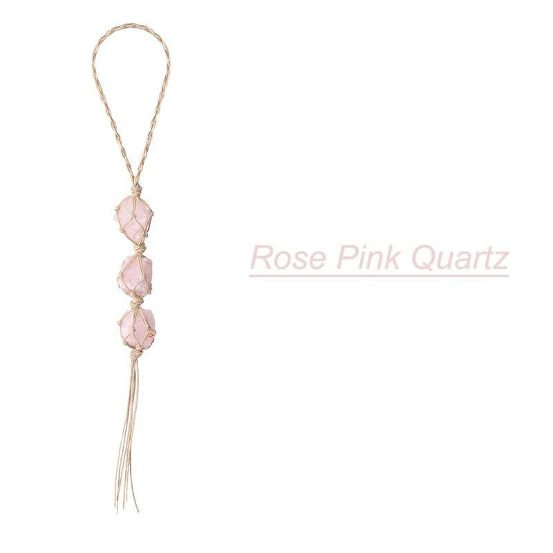 Rose pink quartz irregular natural stone car pendant with three raw crystals knotted on a braided cord.