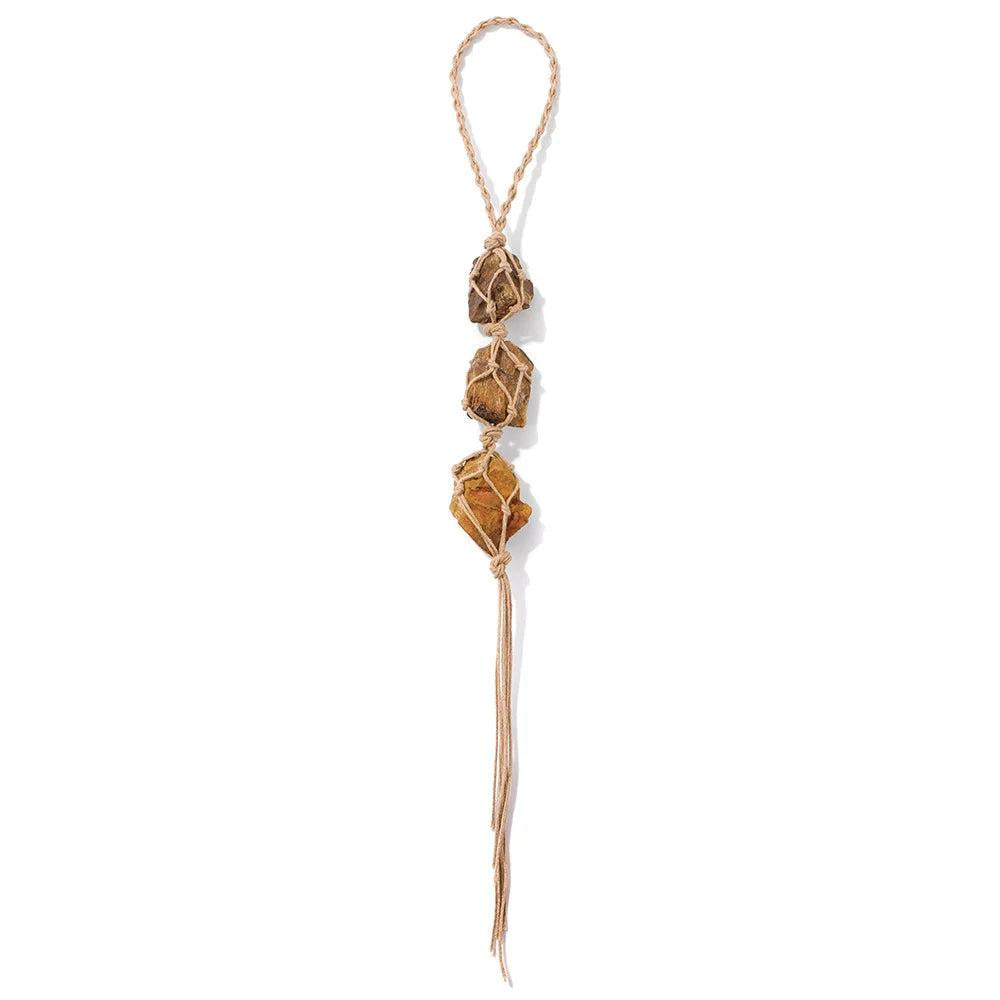 Three irregular raw quartz stones, amber-brown, wrapped in macrame on a beige cord, for car or home decor.