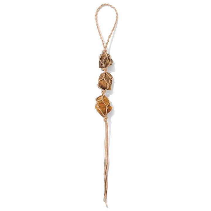 Three irregular raw quartz stones, amber-brown, wrapped in macrame on a beige cord, for car or home decor.