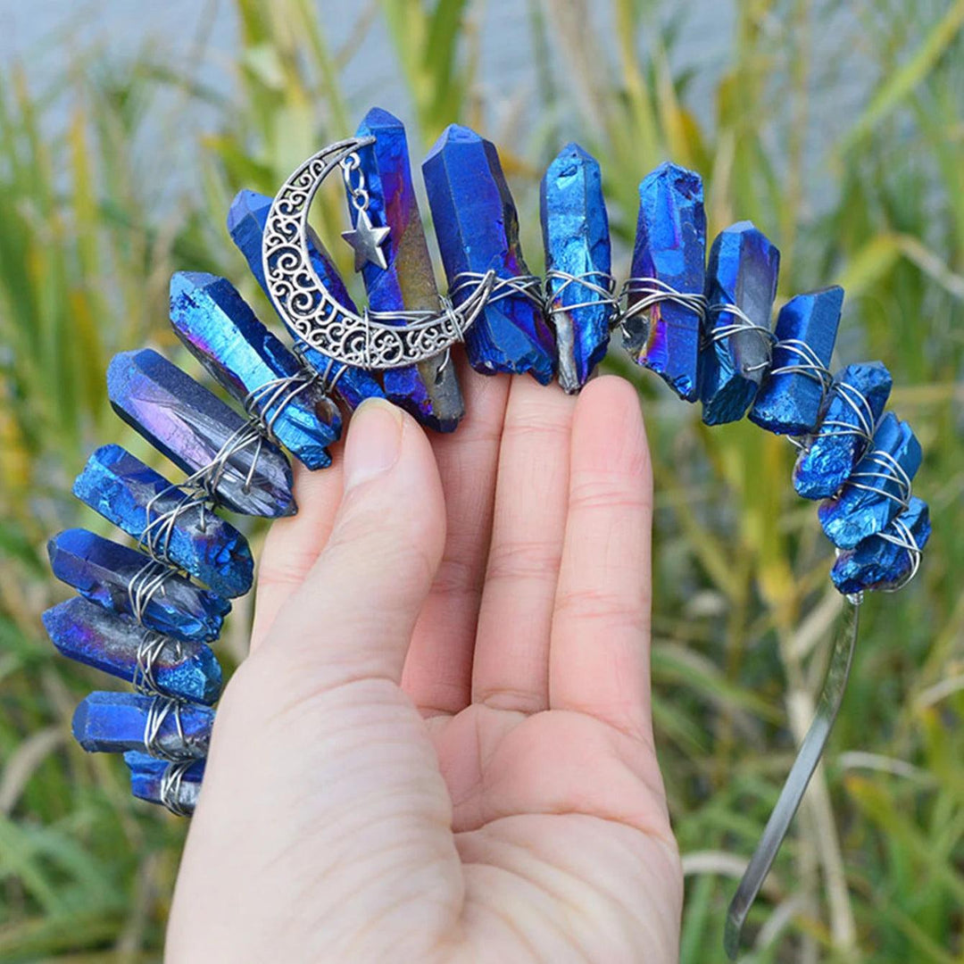 Vibrant blue aura quartz crystal tiara headband with a silver crescent moon and star charm, held by a hand.