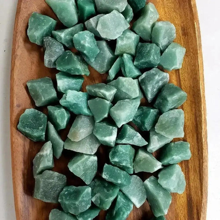 Raw green aventurine stones with a natural, unpolished texture and earthy green hues for Heart chakra healing.