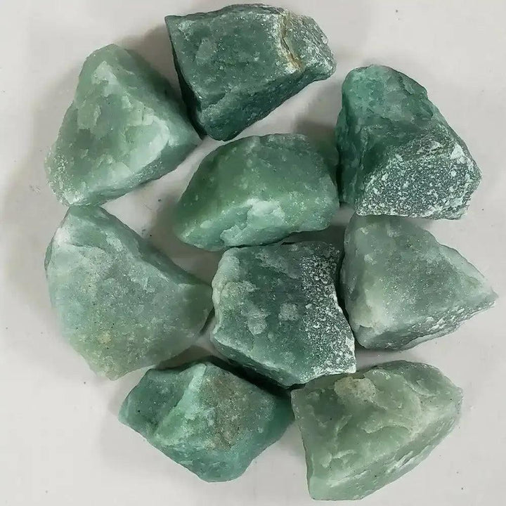 Raw green aventurine stones with a natural, earthy texture and shimmering light green quartz for Heart chakra healing.