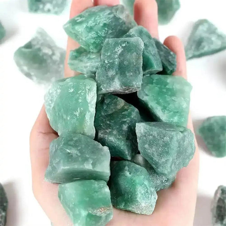 Handful of raw green aventurine stones with a natural, shimmering texture, perfect for Heart chakra healing and growth.