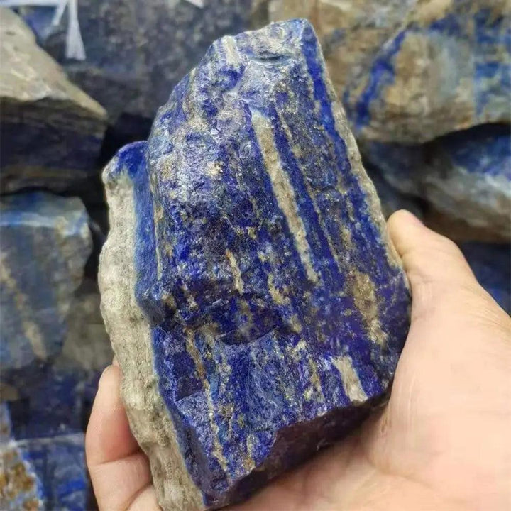 Raw Lapis Lazuli stone with deep royal blue color and golden pyrite flecks, perfect for Throat Chakra healing and altars.