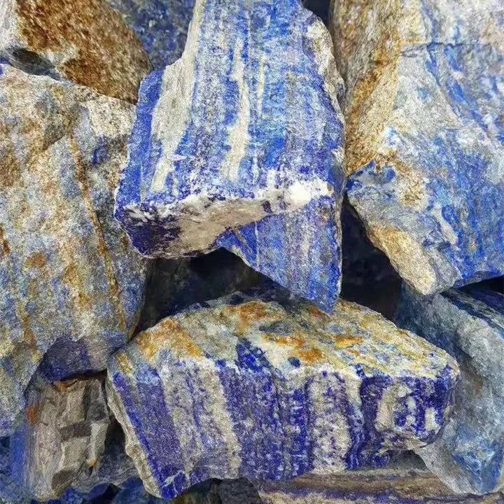 Raw Lapis Lazuli stones featuring deep royal blue hues and golden pyrite flecks for Throat and Third Eye Chakra healing.