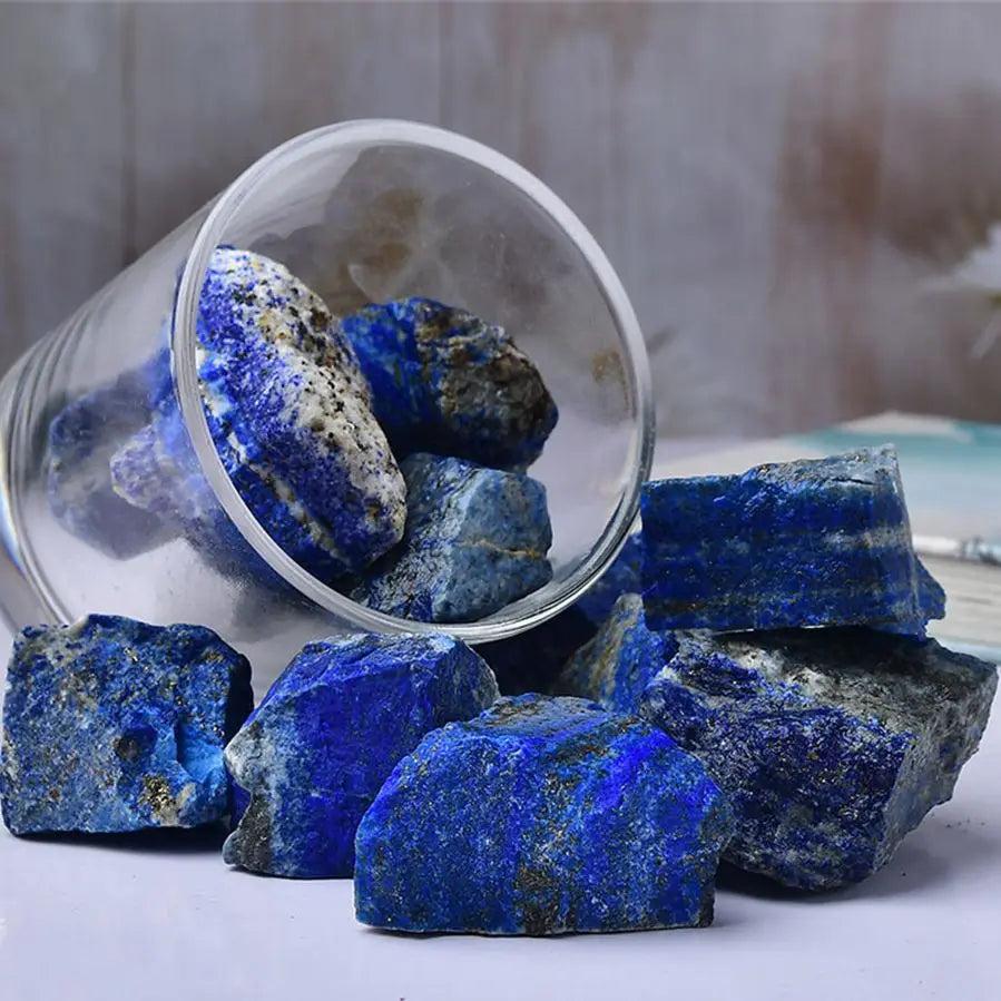 Raw Lapis Lazuli stones with deep royal blue hues and golden pyrite flecks, perfect for Throat Chakra healing and altars.