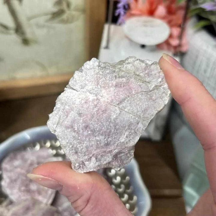 Raw Lepidolite slice with glittering purple and pink mica, a calming natural crystal for emotional balance and relaxation.
