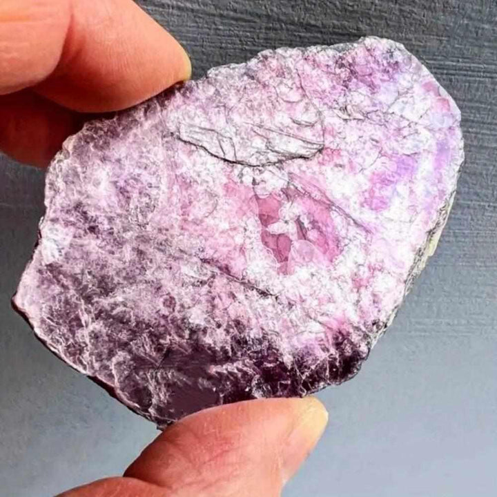 Raw Lepidolite slice featuring shimmering purple and pink mica layers for calming energy and emotional balance.