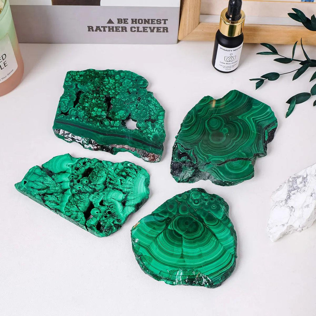 Raw Malachite pieces featuring vivid green bands and natural eye-like rings for Heart Chakra transformation and healing.