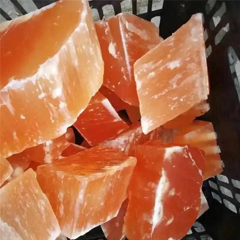 Raw orange selenite chunks with silky, peach-toned fibers and a natural, glowing texture for sacral chakra healing.