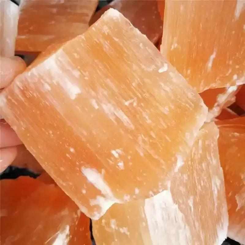 Raw orange selenite chunk with silky peach fibers and a natural, glowing texture for sacral chakra cleansing and energy.