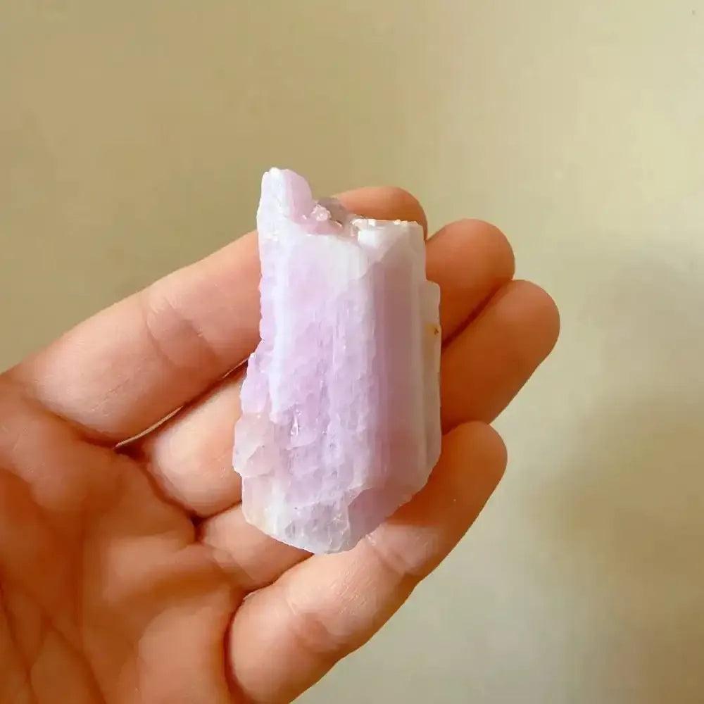 Raw pink kunzite crystal with a glassy, lilac-hued rough texture, perfect for heart chakra healing and meditation.